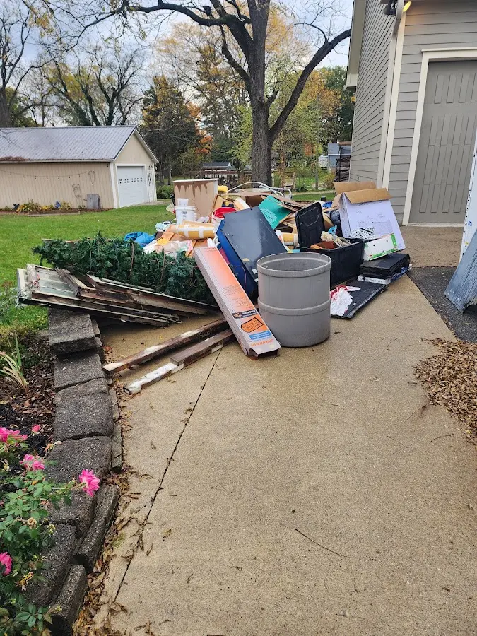 Dumpster being loaded with debris for Estate Cleanout Dumpster Rental in Dardanelle